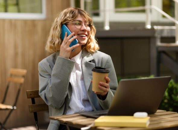 smiley-woman-talking-phone-medium-shot_23-2149476757